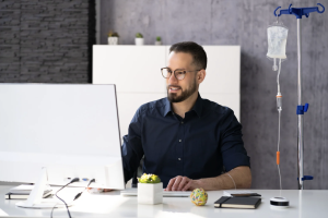 iv therapy on man is who is at work desk