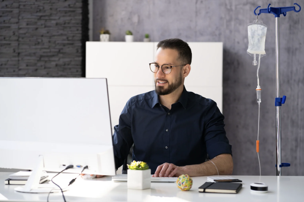 iv therapy on man is who is at work desk