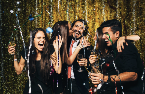 group of friends celebrating nye party and drinking champagne, in need of hangover recovery