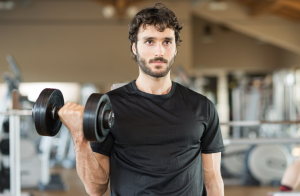 man lifting weights at the gym, needing iv hydration therapy for recovery