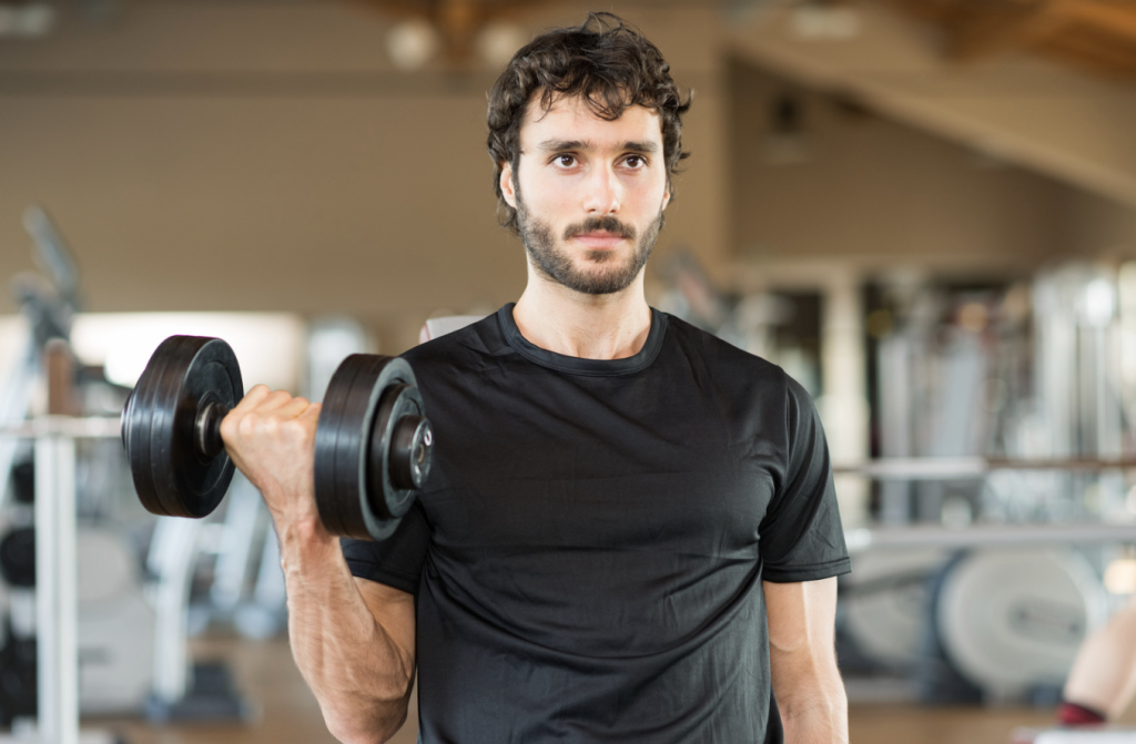 man lifting weights at the gym, needing iv hydration therapy for recovery